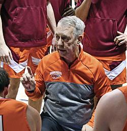 Image of coach Frank Marcinek talking to team in huddle.